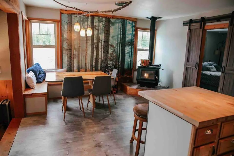 Dining area with eclectic wood burning furnace.