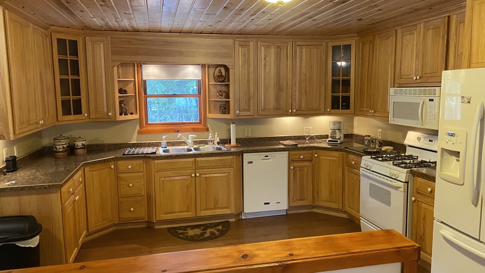 Large kitchen with pots, pans, utensils, coffee maker, toaster, and more! 