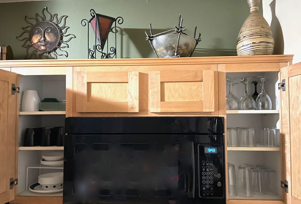 Full kitchen with place settings for four guests.