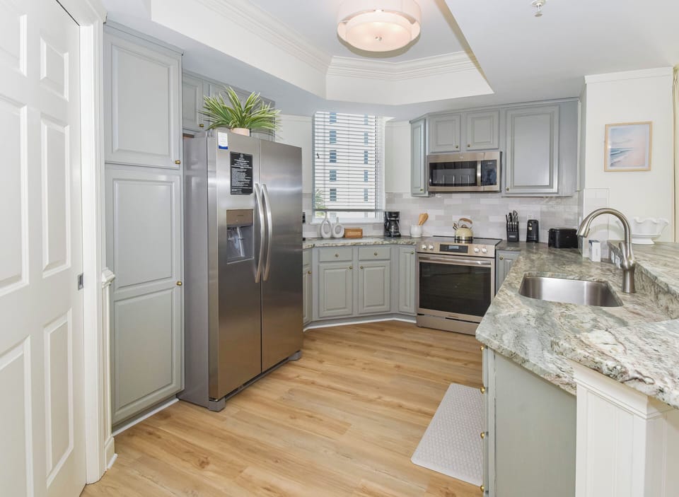 This fully-equipped kitchen invites you to whip up your favorite meals with stainless steel appliances, granite counters, and all the cookware you need for a home-away-from-home experience.