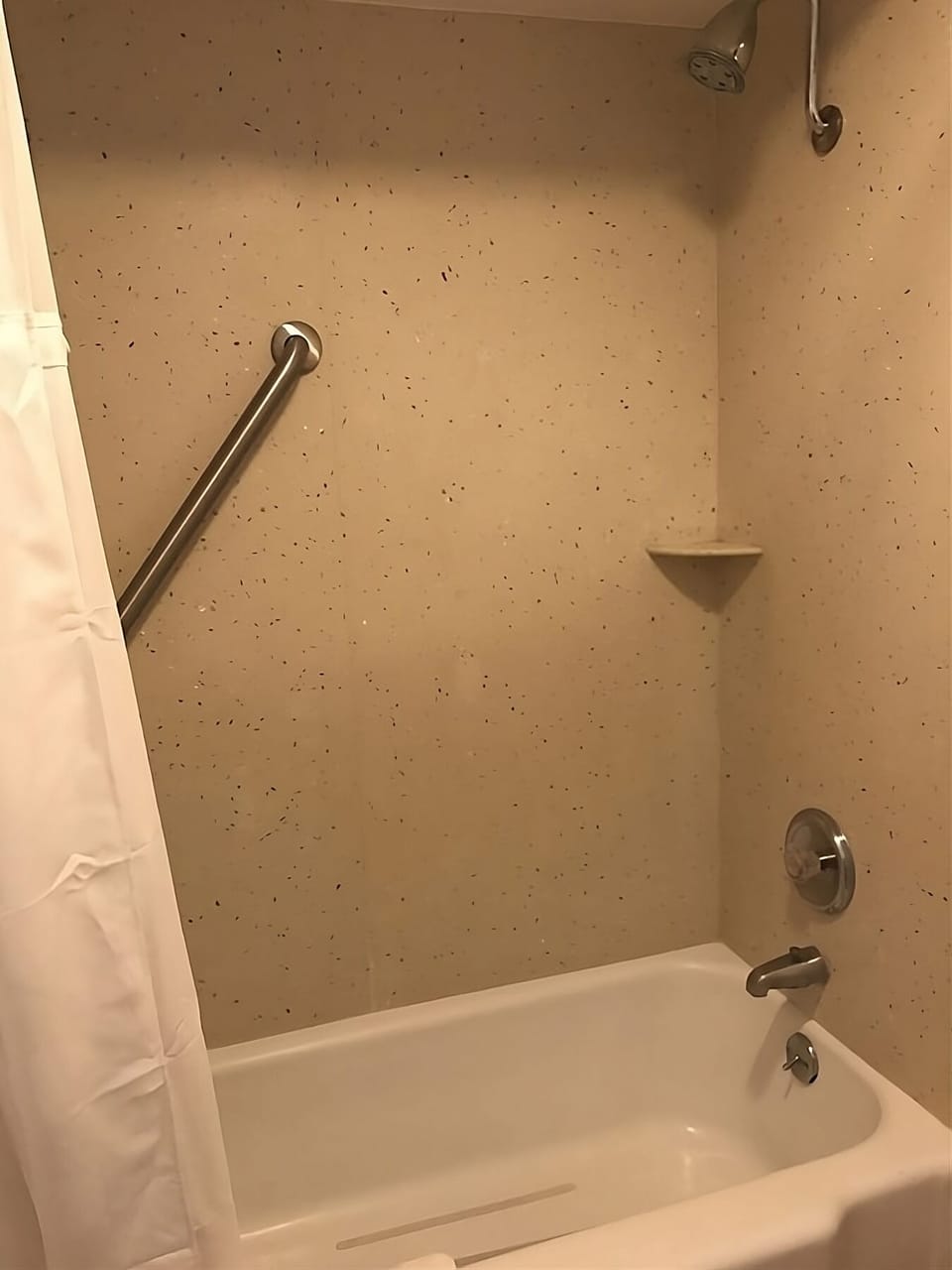 Bathroom with a shower and tub. Basic toiletries and towels are provided