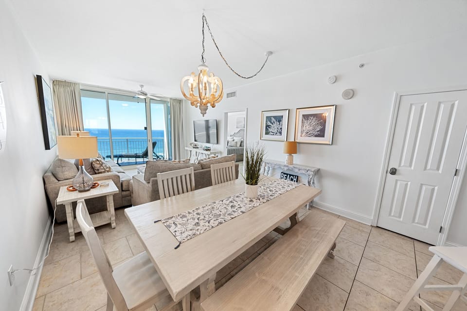 Your bright open-plan living and dining space features stunning ocean views and beachy coastal decor for perfect seaside relaxation.
