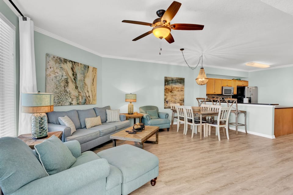 Unwind in your spacious coastal retreat where soft mint walls and comfortable seating create the perfect atmosphere for memorable evenings together.