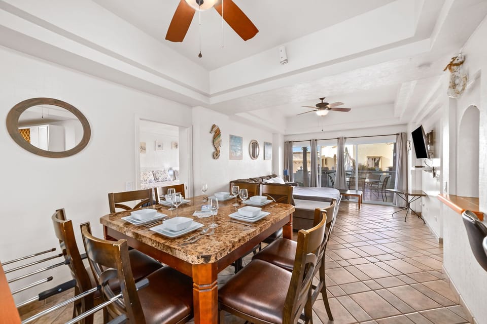 Open-concept layout brings together kitchen, dining, and living areas with stylish tile floors.