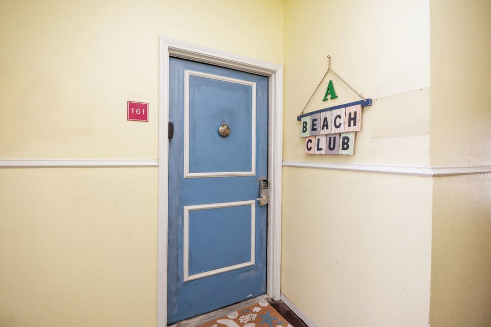 Your beachside retreat awaits behind this charming blue door, where coastal vibes and comfortable accommodations create the perfect seaside escape.