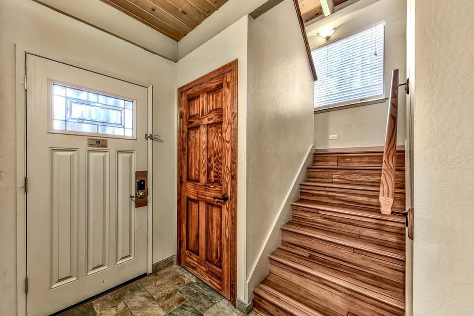 Step into your welcoming entryway with beautiful hardwood stairs leading to your private retreat upstairs.