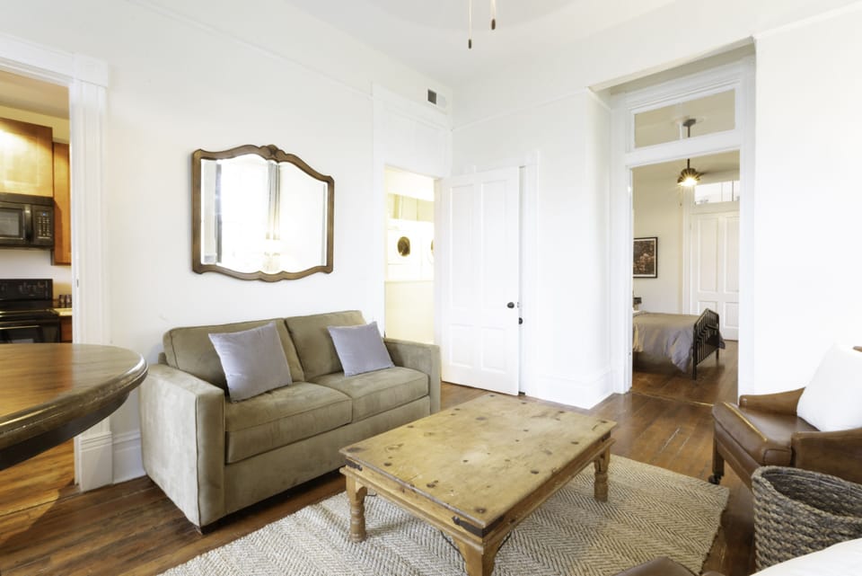 The cozy living room features a smart TV and bar dining table for two.
