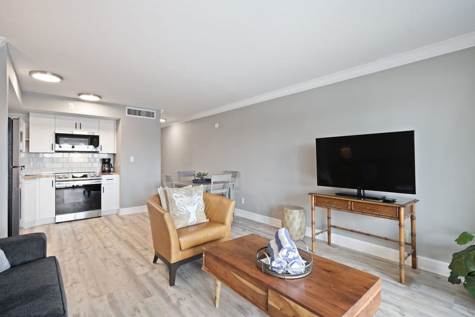 Expansive living room with full kitchen overlooking marina