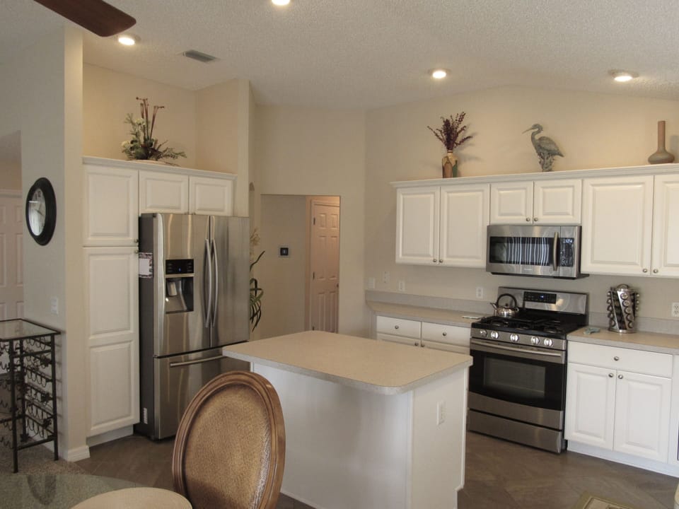 Spacious kitchen with updated stainless steel appliances including a gas stove
