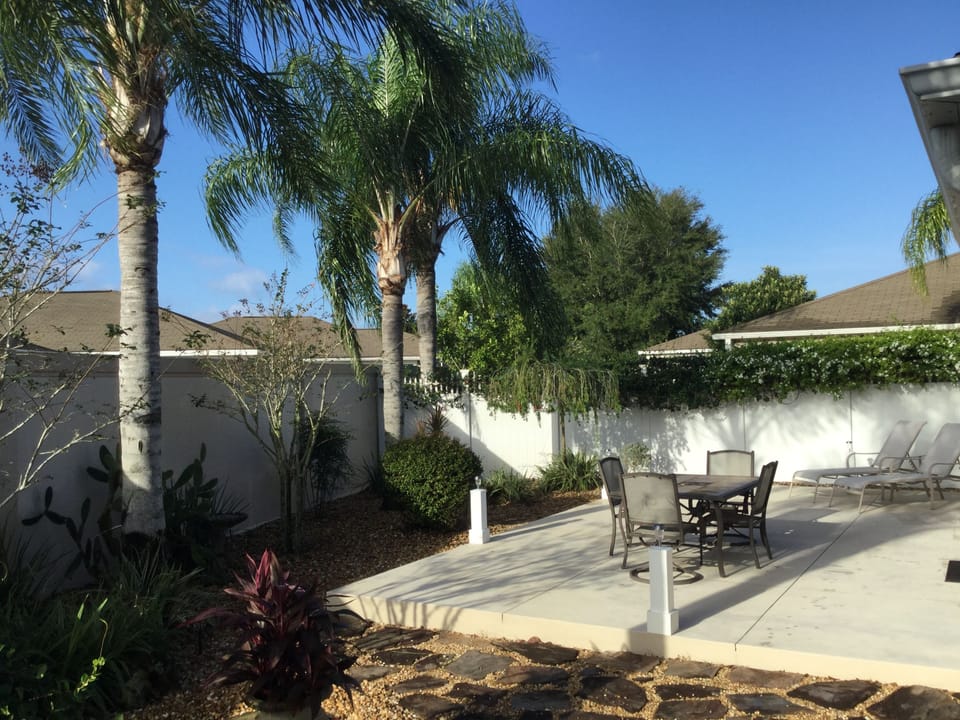 Huge rear patio with dining table for six and lounge chairs