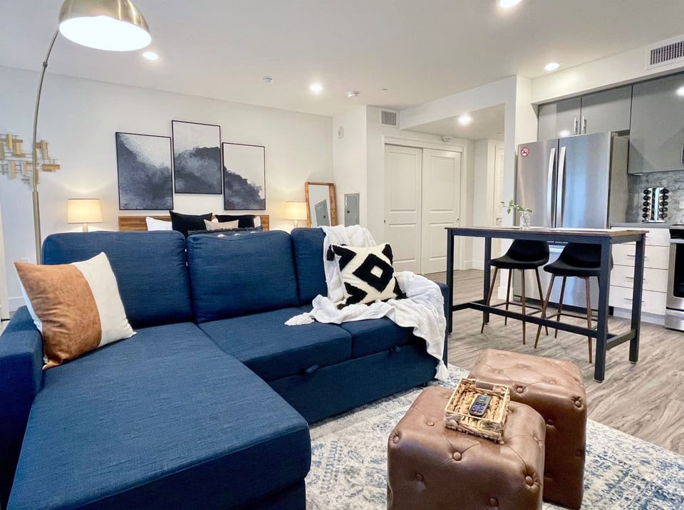 The living area with sofa sleeper and King Bed beyond.