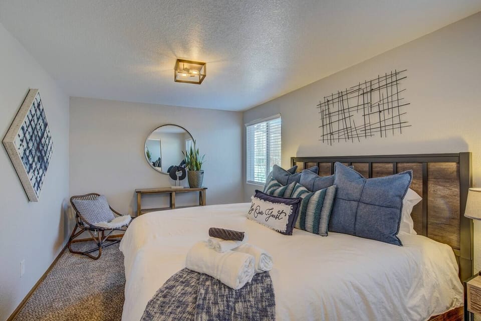 Master Bedroom: Plush bedding and vibrant decor create a serene retreat with mountain views!