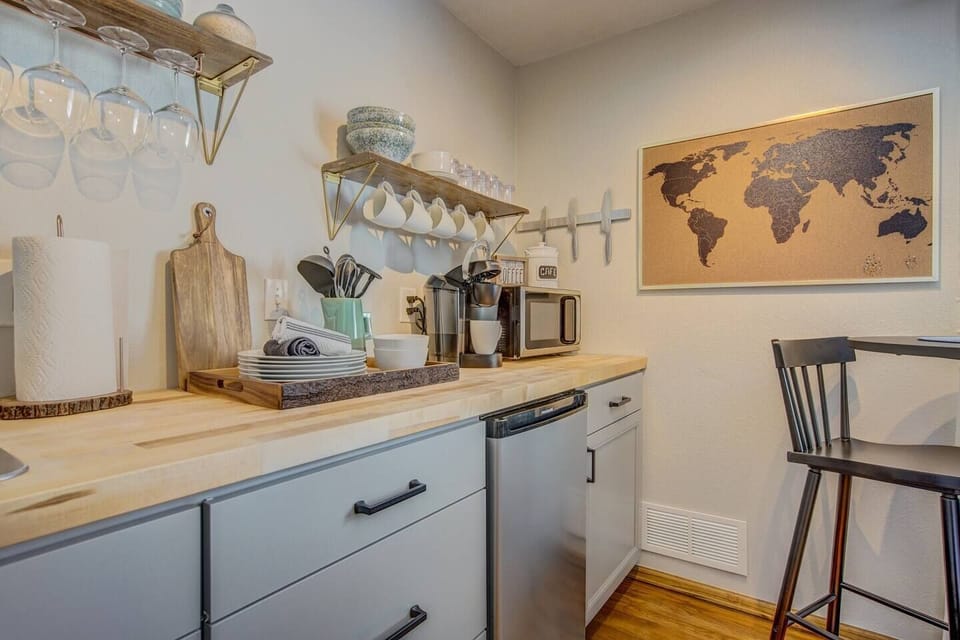 Kitchenette with 2-burner convection cooktop, microwave, toaster oven, hot water kettle, Keurig coffee maker, and all the kitchen tools you need to ready a meal.