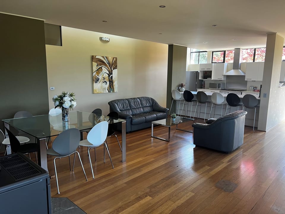 Photo of the second living and dining looking over to the kitchen island bench