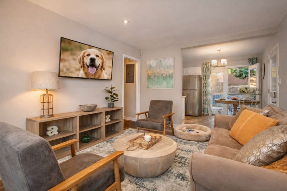 Step inside to an open living space where natural light pours in, the smart TV is ready when you are, and the whole family — four-legged members included — can stretch out and finally exhale. Dogwood Den by Reunion House.