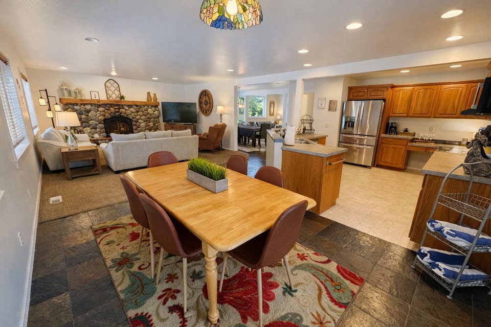 Gather around your beautiful dining table while meals simmer in the full kitchen, then unwind by the stone fireplace in your cozy living space.