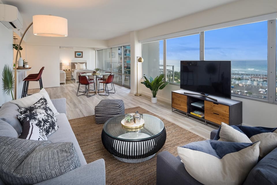 Large, spacious living / dining area - with yacht harbor and pacific ocean views behind TV!