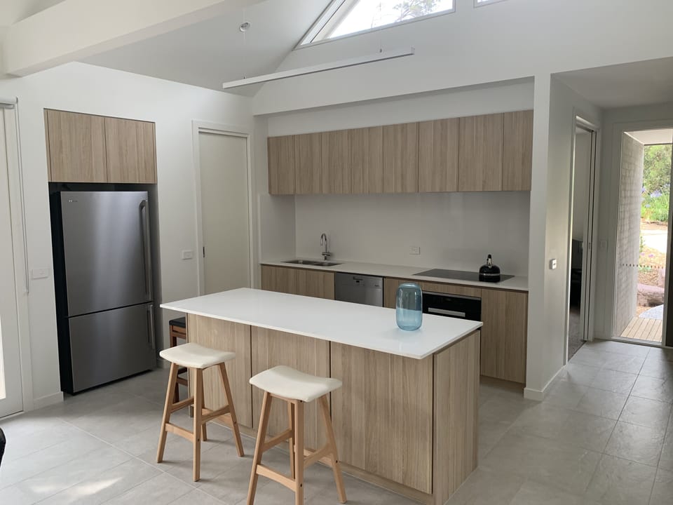 Kitchen with induction cooktop, oven, microwave and dishwasher