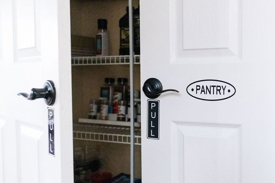 Large pantry stocked with basic cooking oils and spices.