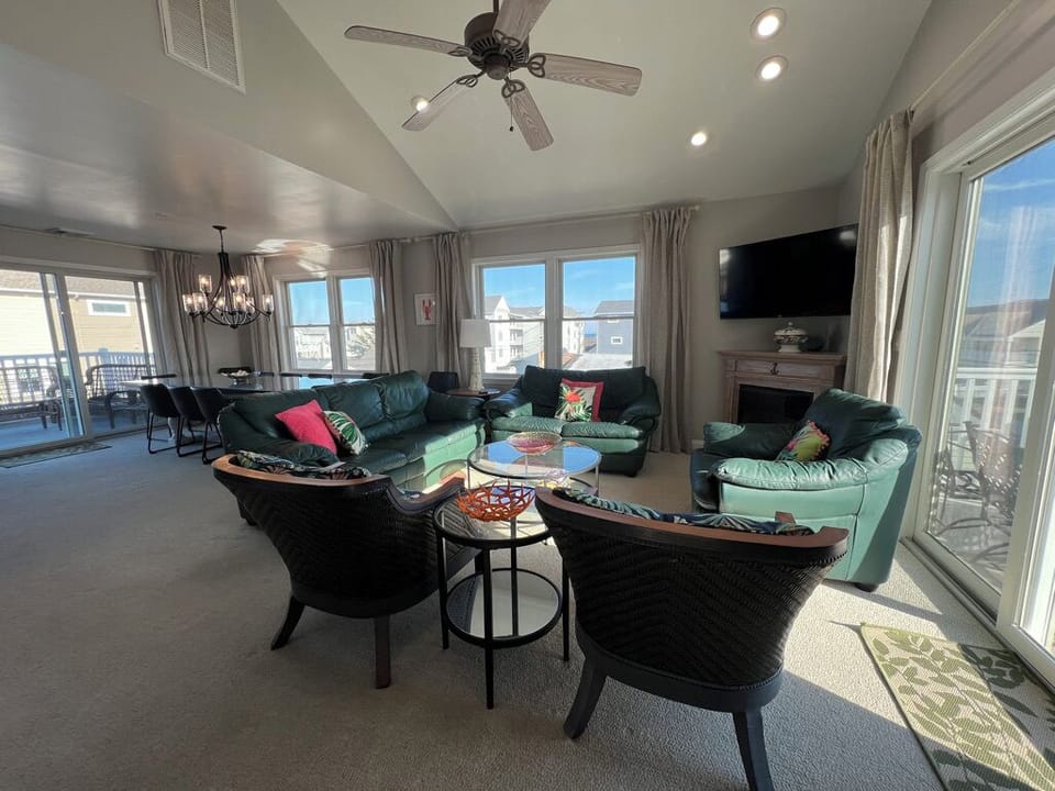 Top floor open concept living, dining, kitchen layout with 2 decks