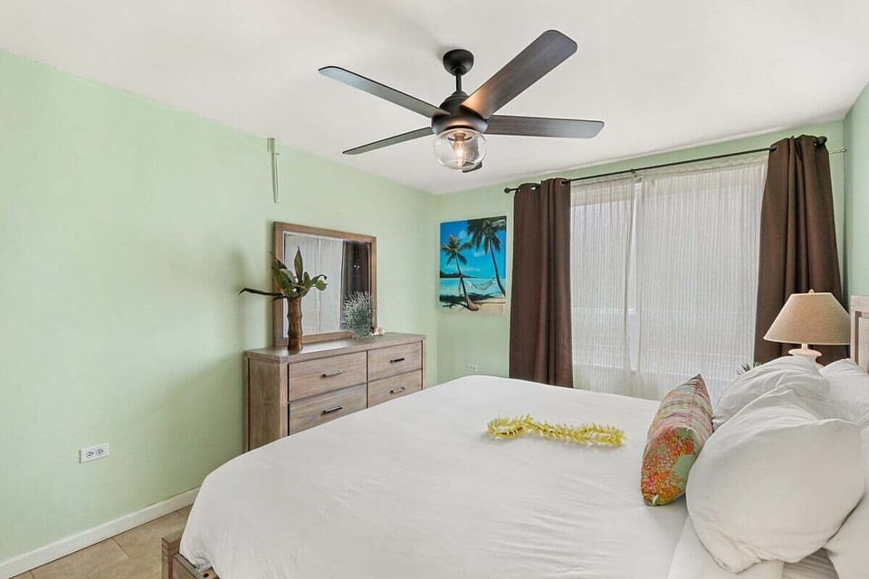 Wake up to comfort and charm—this bedroom blends elegance with a touch of aloha.