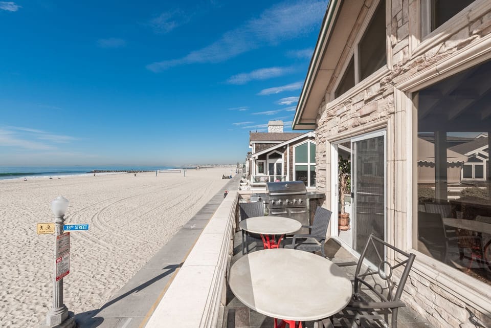 The front balcony deck overlooks the pedestrian boardwalk, sand, and ocean beyond. Keep your eyes peeled for dolphins and whales!
                