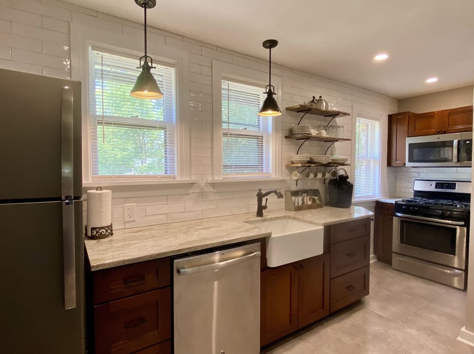 Fully stocked kitchen w/granite, charming farm sink, full size appliances. 