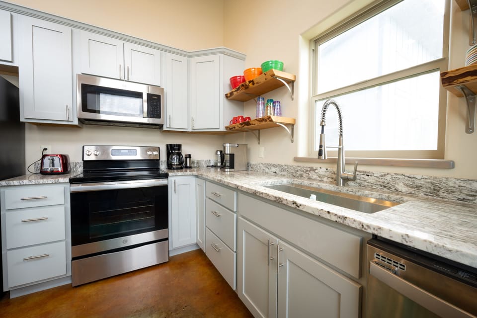 Fully stocked kitchen with keurig, coffee pot, and electric kettle. 