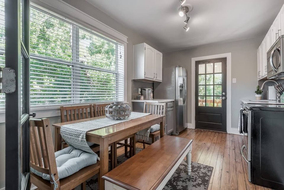 Dining Area: Bright and inviting space to enjoy meals, with a view of lush greenery!