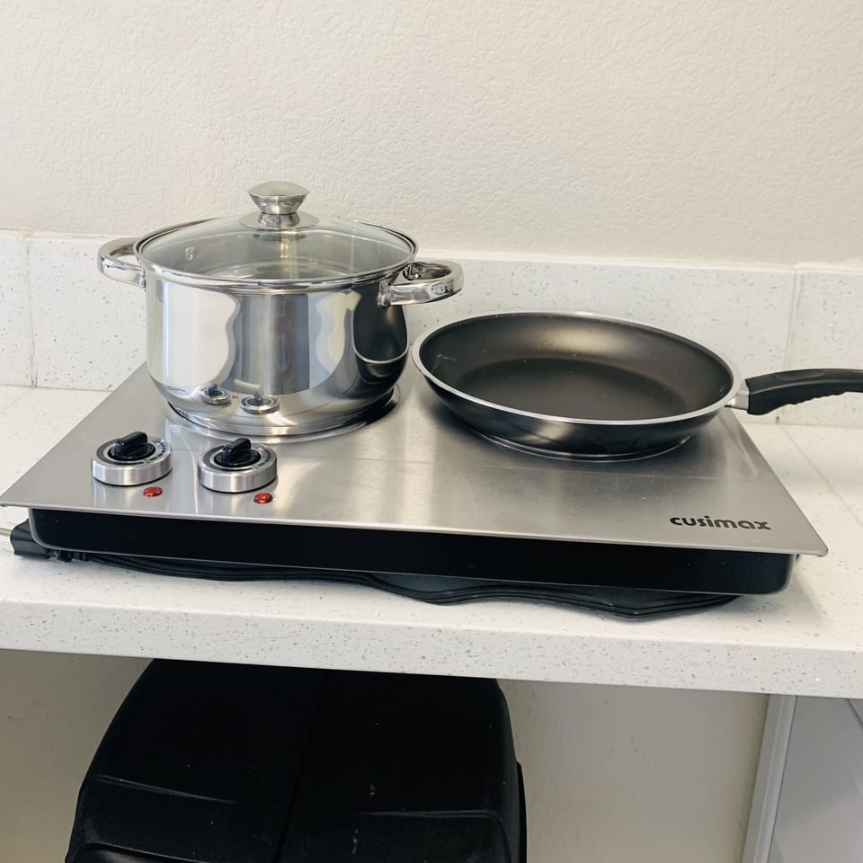 Over the top 2-burner electric stove.
Pots and pans 