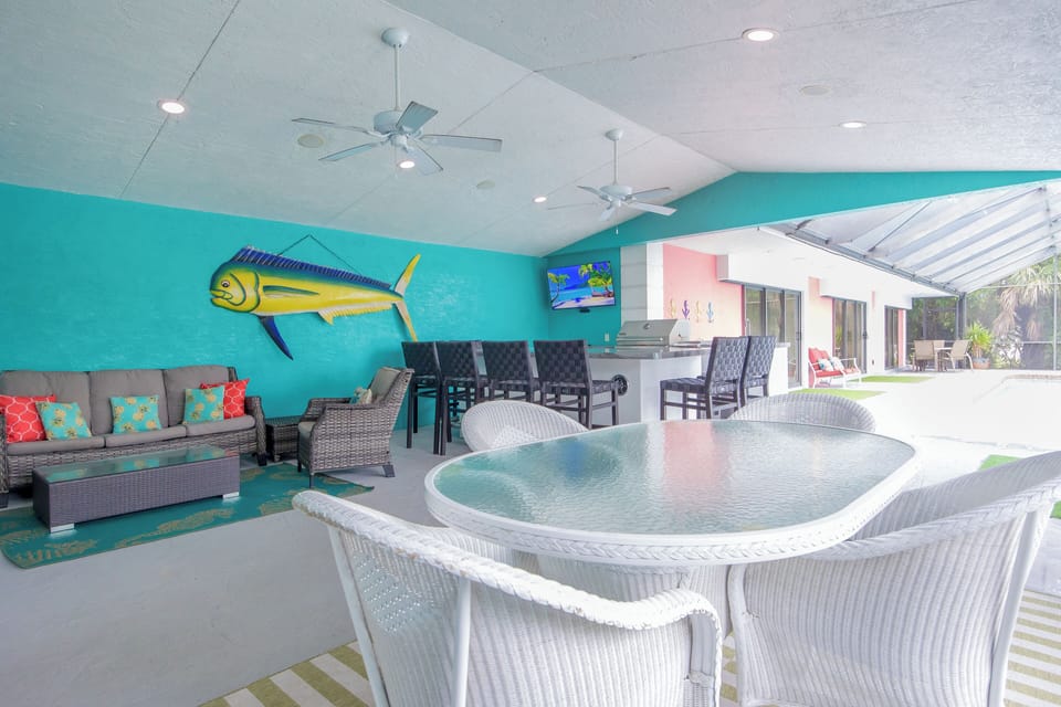 Huge covered, screened lanai space, fans, bar, grill, seating, smart TV.