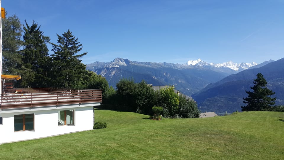 View of the terrace and the mountains from the side of the building
