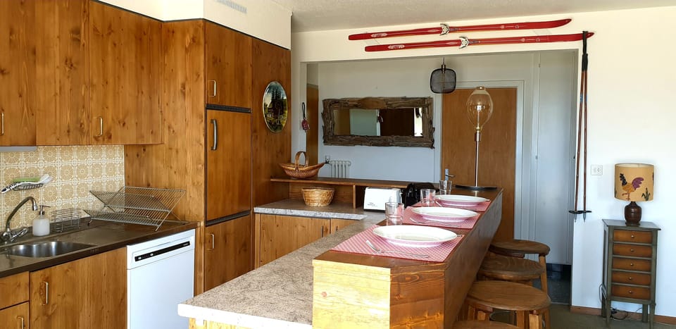 Sunny and bright open bar kitchen overlooking the terrace and the mountains