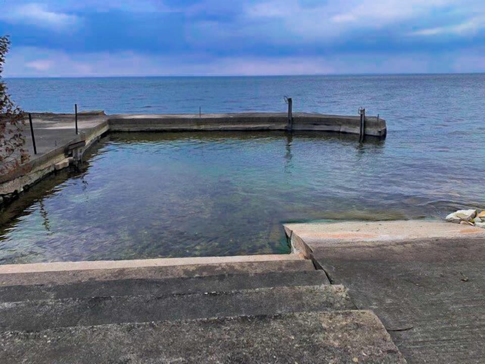 Protected swimming area and kayak launch! Sandy bottom and only a few feet deep! Concrete for safe fishing!