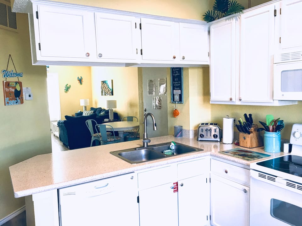 Spacious open-plan kitchen with breakfast bar seating for 3