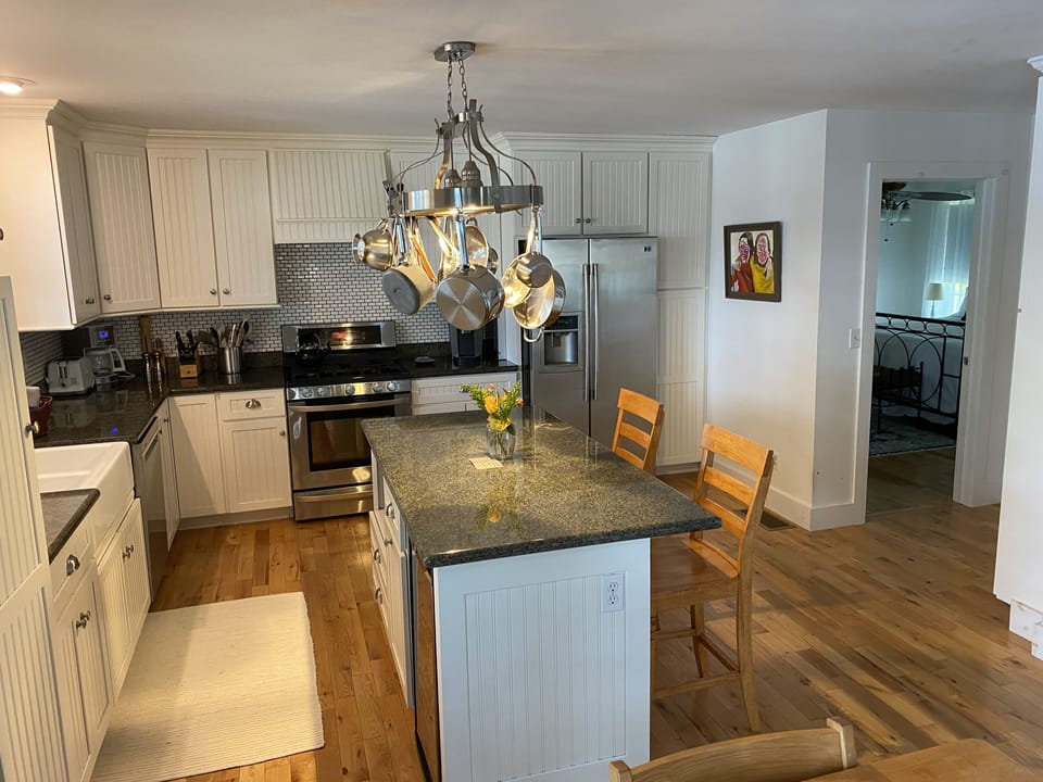 Stainless steel, granite, and custom crafted cabinets accent the modern kitchen.
