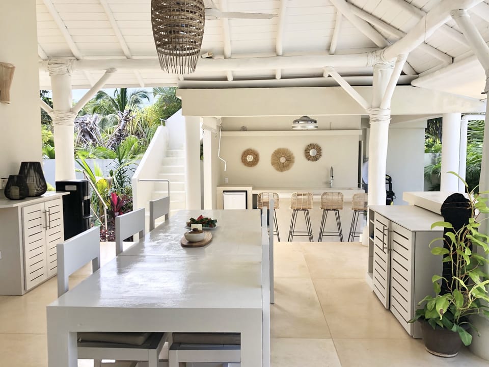 dining table and bar area with stairs on the left to roof terra