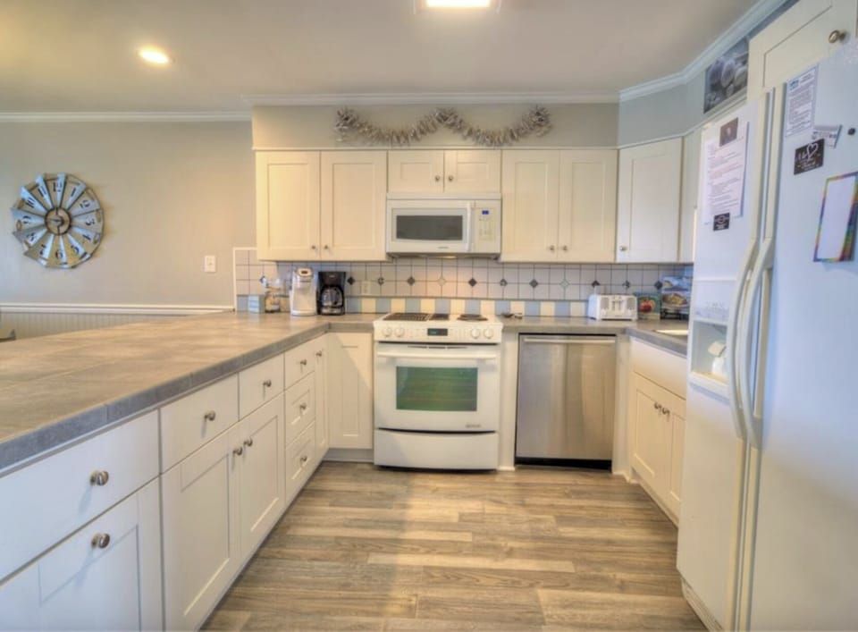 Fully stocked kitchen with Keurig coffee maker.