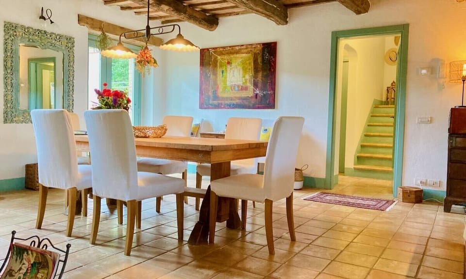 The spacious dining area with original beams and natural teak dining table for 8