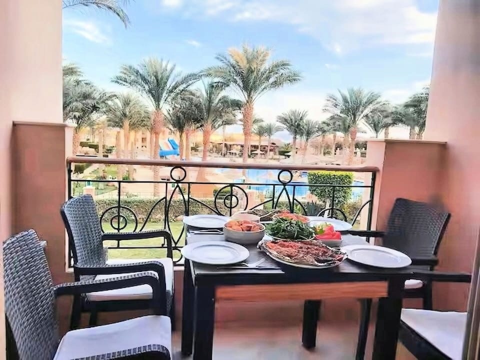 Balcony overlooking garden and swimming pool
