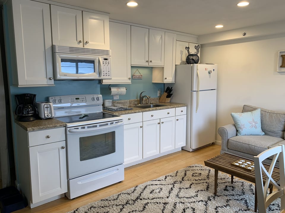 Fully stocked kitchen. 
Large pots toaster coffee pot bowels plates silverware 