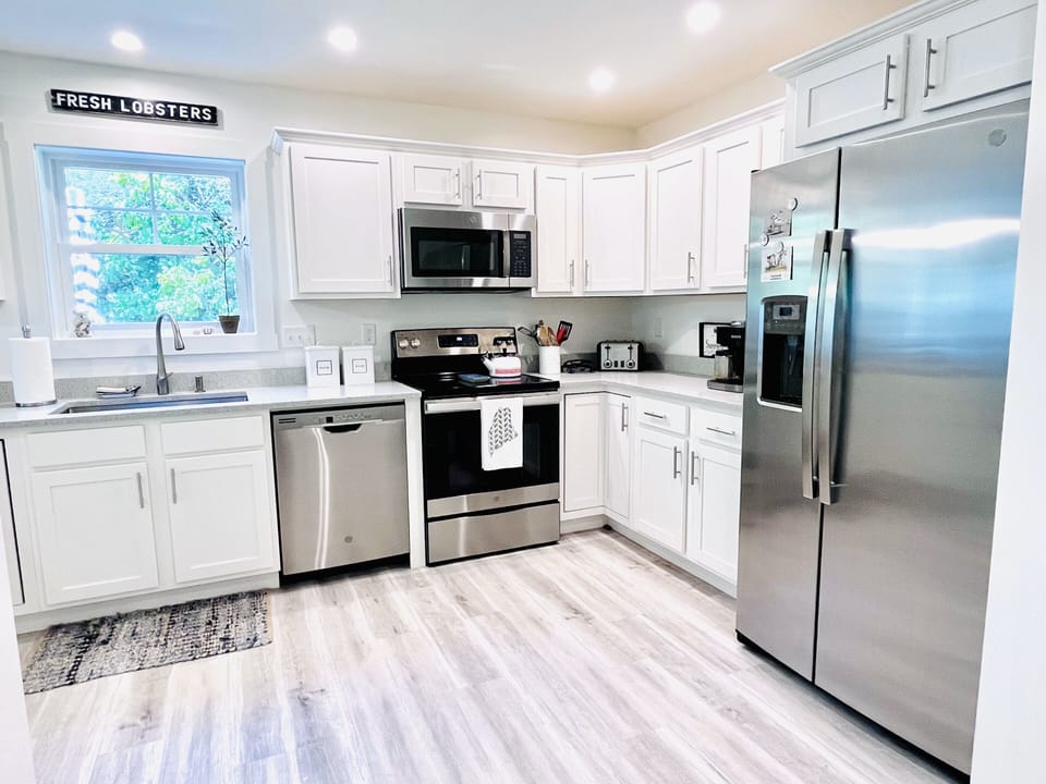 Enjoy this large kitchen with peaceful views of the wooded back yard and patio. 