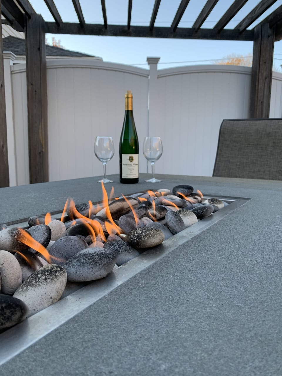 Natural gas fire insert in bluestone table on outside deck.