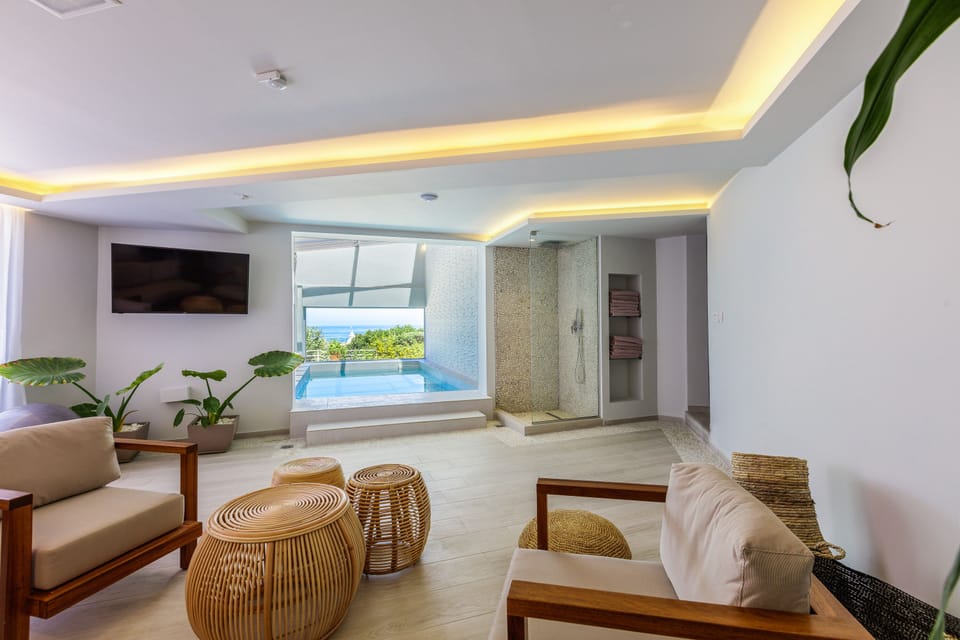 Relaxing spa area with indoor hydromassage pool and gym equipment