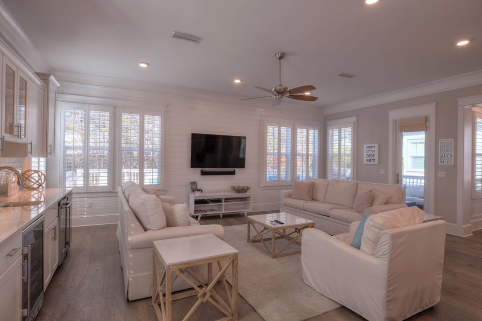 Living room detail with wall-mounted TV and comfortable seating.