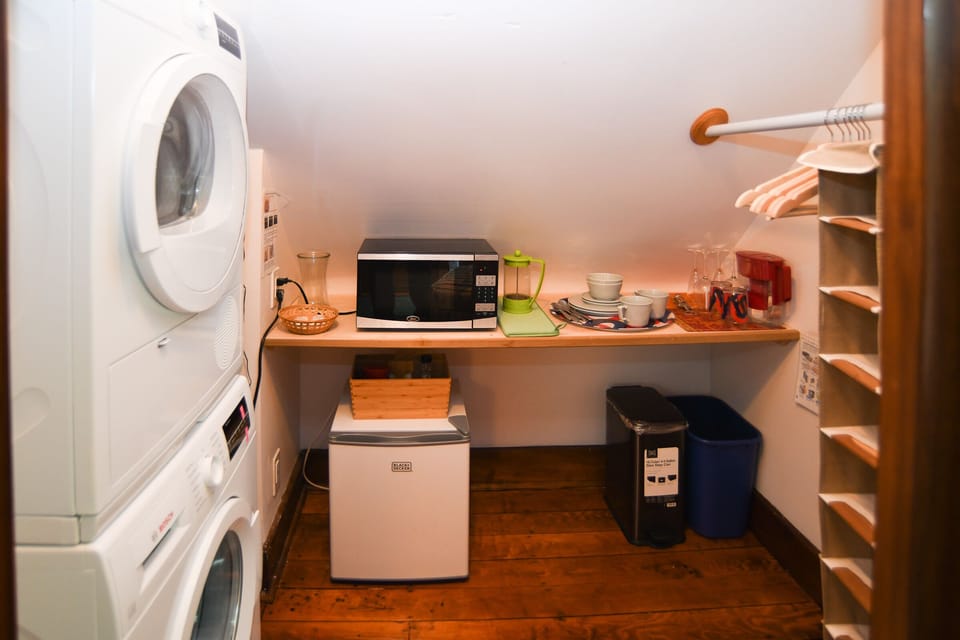 Washer/dryer, microwave, mini-fridge and some essentials.