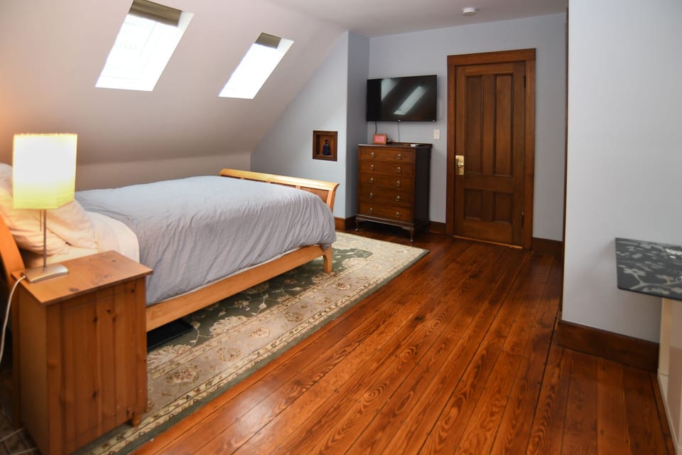 Large and bright bedroom with storage space and 43" Roku TV. 