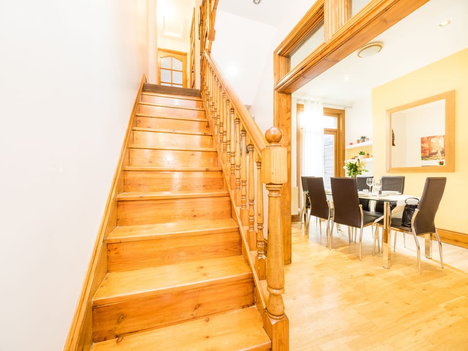 Staircase from dining area leading to upstairs bedrooms