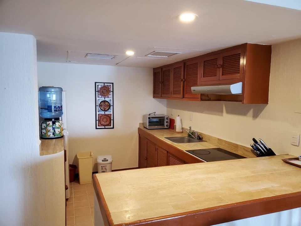 kitchen with cook top, fridge, microwave, toaster oven