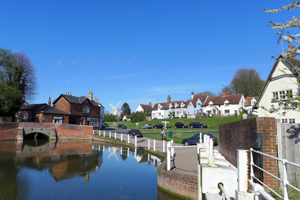 View across the duck pond with cottage in the background 